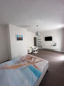 a bedroom with a bed and a flat screen tv at FALEZA Dębina in Debina +36 photos