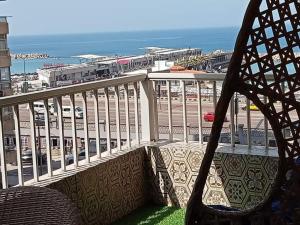 a balcony with a chair and a view of the ocean at شقه مصيفيه للايجار مباشره على البحر في مصطفى كامل الظباط in Alexandria