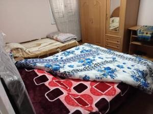 a bed in a room with two blankets on it at شقه مصيفيه للايجار مباشره على البحر في مصطفى كامل الظباط in Alexandria