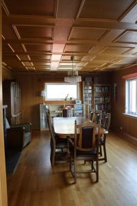 a dining room with a table and chairs at Gammelbutikken Guesthouse in Pettvik