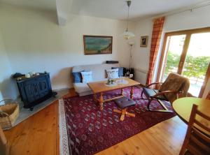 a living room with a couch and a table at Villa Beata Apartment 1 upper floor in Kulen Vakuf +23 photos