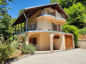 a house with a balcony on top of it at Villa Beata Apartment 1 upper floor in Kulen Vakuf