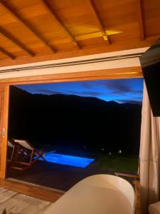 a window with a view of a mountain view at Cabana Girassol com piscina aquecida e cesta para café da manhã in Gonçalves
