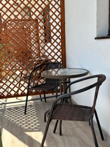 two chairs and a table and two tables and chairs at Vila Bloom in Vama Veche +36 photos