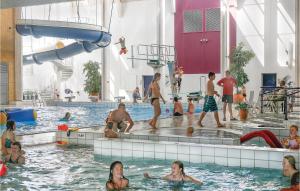 a group of people in the water at a swimming pool at Skærbæk Fritidscenter in Skærbæk