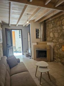a living room with a couch and a fireplace at Lofou Maisonette in Lofou