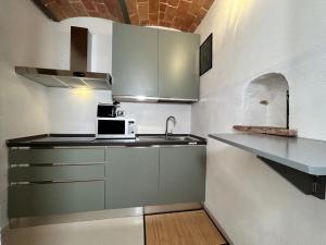a small kitchen with a sink and a microwave at Maremma Toscana Apartment in Manciano