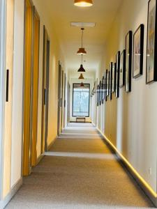 an empty hallway in a building with paintings on the walls at Farmstay in Central Victoria in Ballan