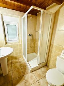 a bathroom with a shower and a toilet and a sink at Casa Nieves Alojamiento Rural in Ampuero +36 photos
