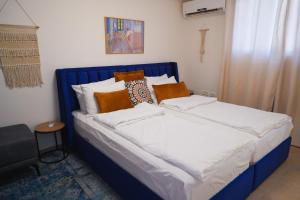 a blue and white bed in a room at צימר - על פלגי מים in Menaẖemya