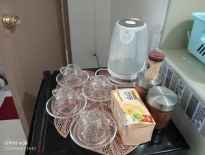 a table with wine glasses and other items on it at RY Nest main in Malaybalay +7 photos