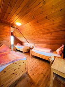 a room with two beds in a wooden cabin at Haus Lahneck bei Koblenz in Lahnstein