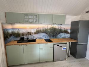Una cocina con fregadero y encimera con una playa en Ośrodek Wczasowy Amelia, en Jarosławiec