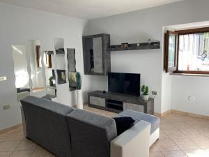 a living room with a couch and a tv at Suite Morruzze in Morruzze