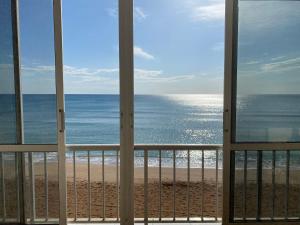 a view of the beach from a balcony at Caballito de Mar in Tavernes de Valldigna