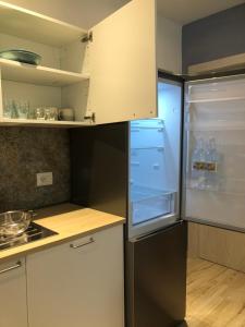 a kitchen with an open refrigerator with water bottles in it at Appartamento I Canali in Rio nellʼElba