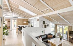 a living room and kitchen with a couch and a table at 4 Bedroom Nice Home In Saltum in Saltum