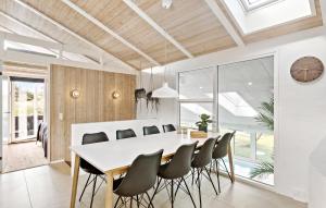 a dining room with a white table and chairs at 4 Bedroom Nice Home In Saltum in Saltum