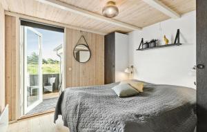 a bedroom with a bed and a large window at 4 Bedroom Nice Home In Saltum in Saltum +11 photos