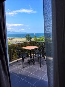 a table and chairs on a balcony with a view of the beach at Blue Sea Hotel in Trabzon