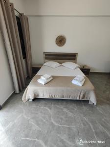 a bedroom with a bed with two towels on it at The View House 2 in Kithnos