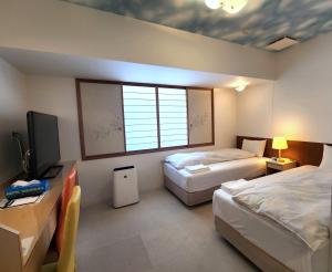 Кровать или кровати в номере Hotel Nishimura