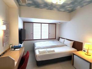 Postel nebo postele na pokoji v ubytování Hotel Nishimura