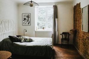 a bedroom with a bed and a window at Ķimales muiža in Ķimale