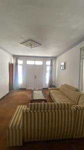 a living room with two couches and a table at Homestay Azalea in Dieng