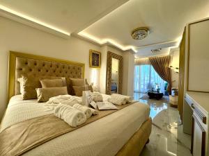 a bedroom with a large bed with towels on it at Mare Suites 4 in Chania