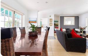 a living room with a wooden table and chairs at Art House in Stellenbosch