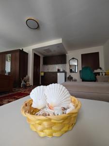 a basket filled with shells sitting on a table at Beatrix Suites in Budva