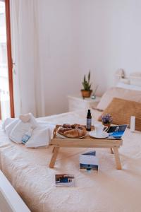 a table with a plate of food on a bed at Casa Ferrari Vista Mare in Formia +19 photos