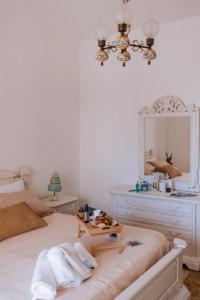 a bedroom with a bed with a mirror and towels at Casa Ferrari Vista Mare in Formia