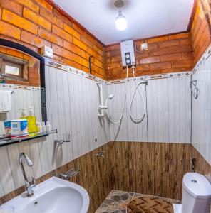a bathroom with a shower and a sink at JayS Place Matale in Kavudupelella