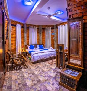 a bedroom with a bed and chairs in a room at JayS Place Matale in Kavudupelella