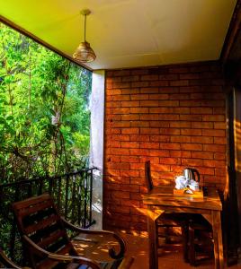 a room with a table and chairs on a balcony at JayS Place Matale in Kavudupelella +22 photos