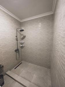 a bathroom with a shower in the corner at Marmar Family Restaurant and Hotel in Nukus