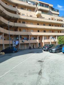 a parking lot in front of a large building at Benvenuti a casa in Pisa