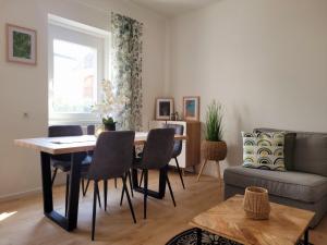 a living room with a table and chairs and a couch at Casa Melina in Mörbisch am See