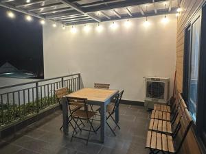 a table and chairs on a balcony with a heater at Á Châu homestay in Ấp Thanh Sơn (1)