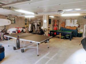 a living room with a ping pong table in it at La " Villa " du JET in Ergué-Gabéric
