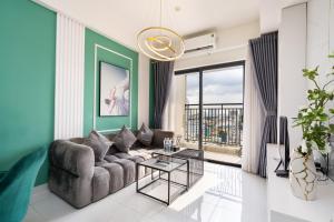a living room with a couch and a table at Otis Soho Saigon Balcony Apartment in Ho Chi Minh City