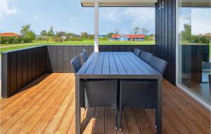 a blue table and chairs on a deck at Four-Bedroom Holiday Home In Nordborg in Nordborg +15 photos