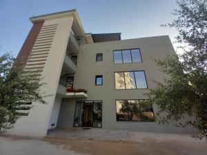 a large white house with windows at Hotel Ksamili in Ksamil +34 photos