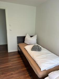 a bed with two pillows on it in a room at Ferienwohnung FördeGlück an der Kieler Förde in Mönkeberg