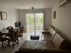 a living room with a couch and a table at Hana Nissi in Ayia Napa