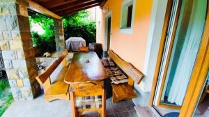 a long wooden table and chairs on a patio at Apartment Wine & Olive oil Mofardin in Koper