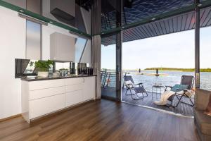 an open kitchen with a view of the water at Domy Na Wodzie 3Miasto in Gdańsk