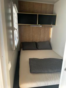 a small bedroom with a bed in a small room at Villa Kiara in Vodice